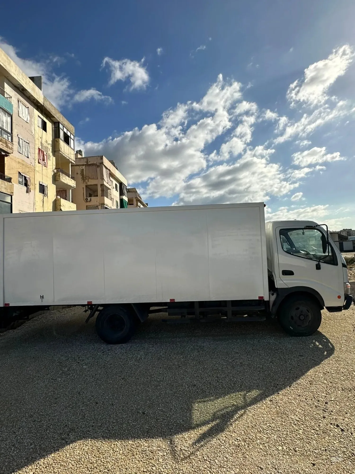 The Aman box truck before the wrap, plain white