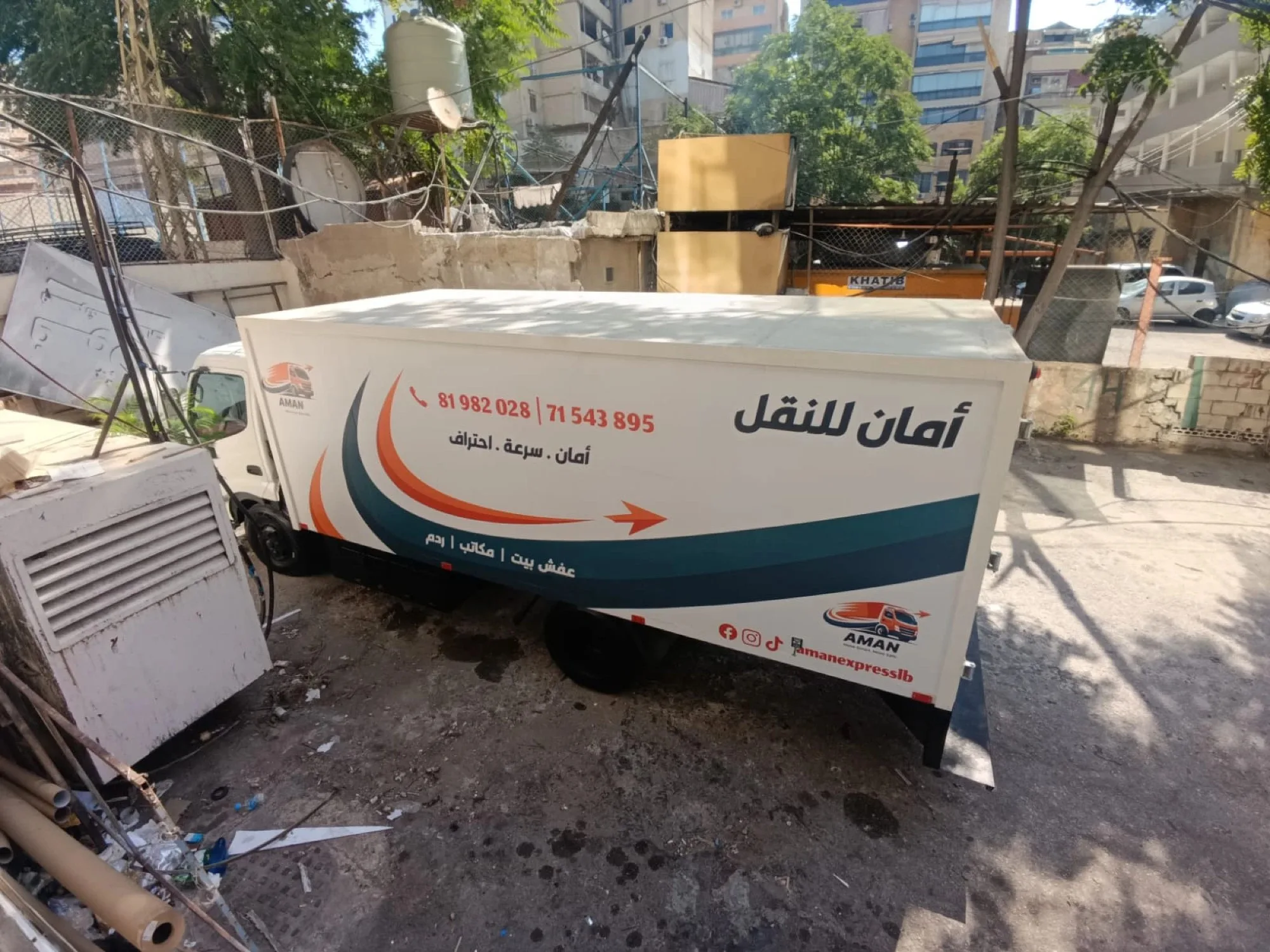 The wrapped Aman truck parked, ready for work